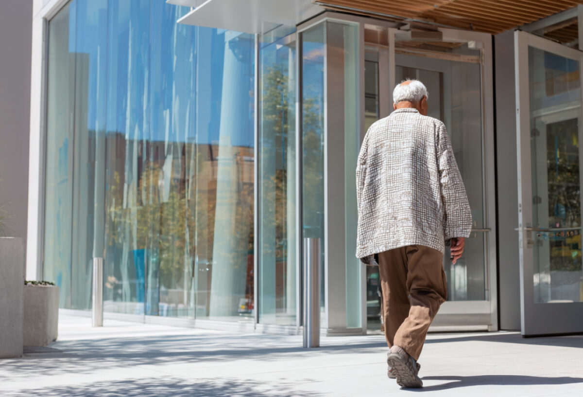 A senior entering a building